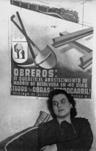 Muriel Rukeyser in front of a Spanish Civil War poster.