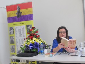 Dawn Purvis reads from They Shall Not Pass. Behind her is the Roll of Honor of Irish participants in the SCW.