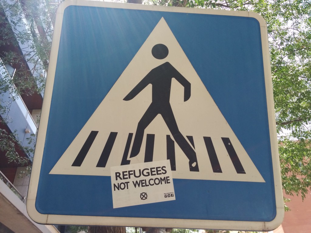 “Refugees Not Welcome” sticker on a traffic sign in Córdoba, Spain. Photo Rafael Robles. CC BY 2.0