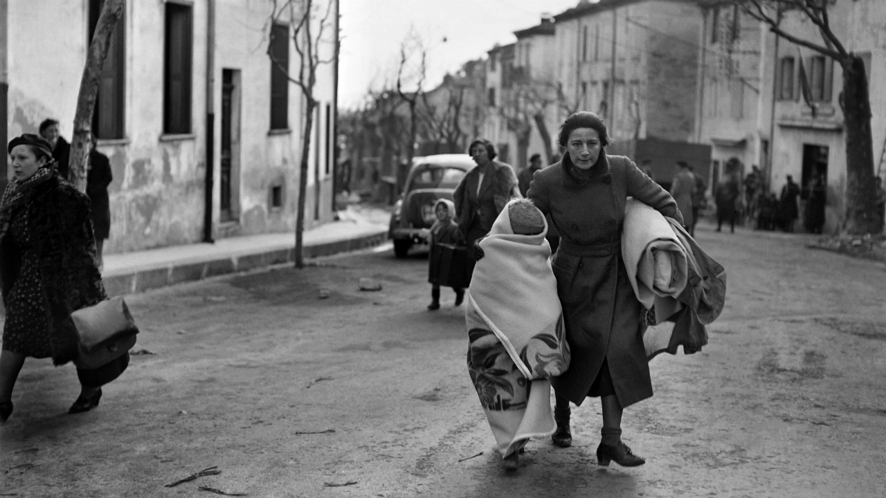 A photo dated February 1939 of a woman and her child arriving on foot in the southeastern French border town of Perthus. AFP